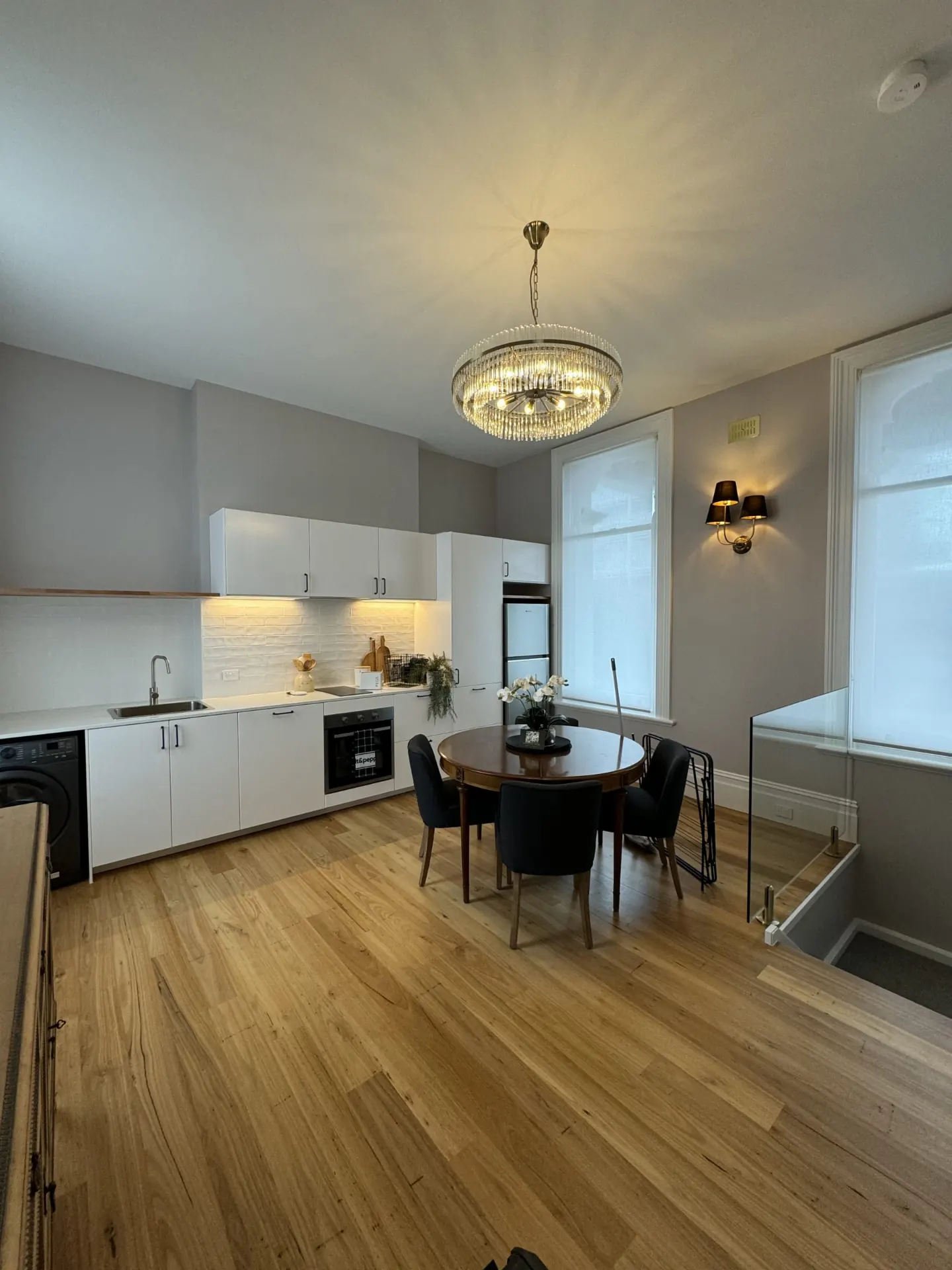 Chandelier, wall sconce and under-cabinet lighting installed in a Newcastle kitchen and dining area